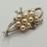 A 14ct white gold diamond and pearl brooch