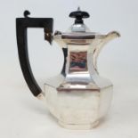 A George V silver hot water jug, with ebonised handles, Birmingham 1919, all in weight 10.6 ozt