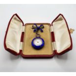A ladies silver coloured metal, seed pearl and enamel fob watch, on a ribbon tie bow support, in a