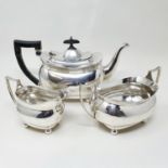 A George V silver three piece tea set, the teapot with an ebonised handle, Chester 1912, all in 3.