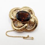 A late 19th/early 20th century yellow metal and amber stone brooch All in 14.9 g, visible repair