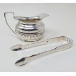 A pair of George III silver sugar nips, London 1813, and an Edward VII cream jug, Chester 1934, 3.