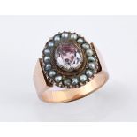 An antique yellow metal, pink stone and pearl ring, ring size M
