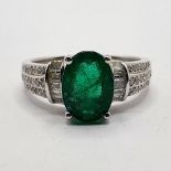A 14ct white gold, diamond, and emerald ring, ring size N 1/2