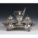 An Edward VII silver desk stand, center bowl with a miniature chamber stick, flanked by cut glass