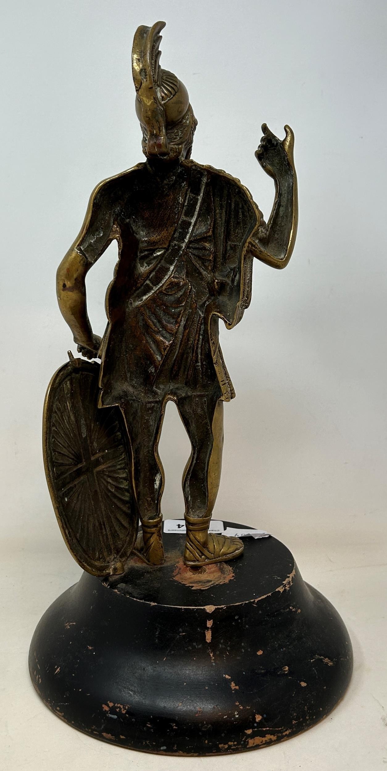 A brass figure of a Roman centurion, 30 cm high, on a later ebonised base Some wear to the figure, - Image 3 of 3