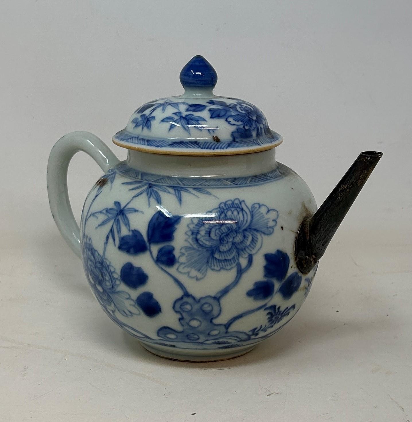 A Chinese porcelain teapot and cover, with floral decoration in underglaze blue, 13.5 cm high