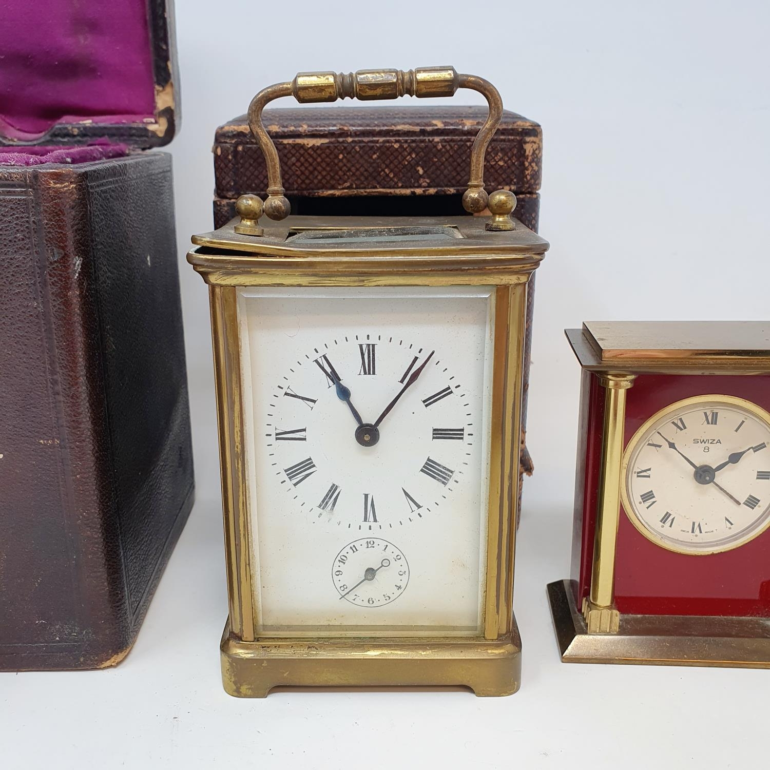 A carriage clock, the 5.5 cm wide enamel dial with Roman numerals, and a subsidiary alarm dial, in a