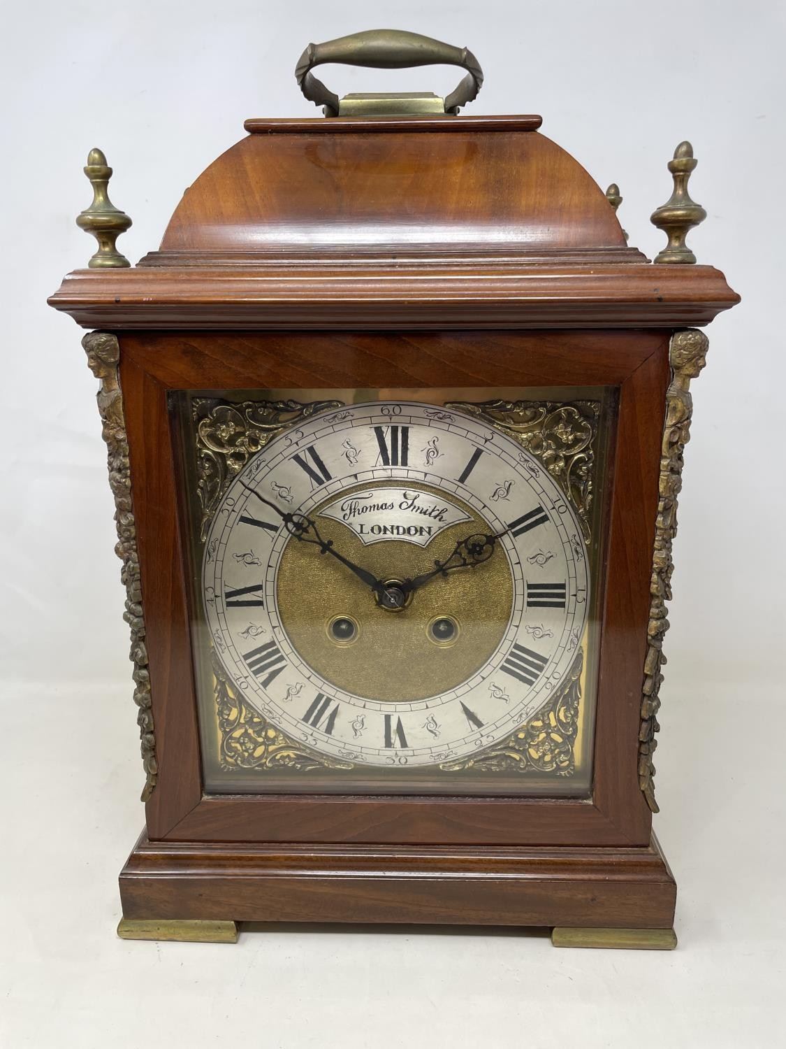 An 18th century style bracket clock, the arched brass dial signed Thomas Smith, London, with a