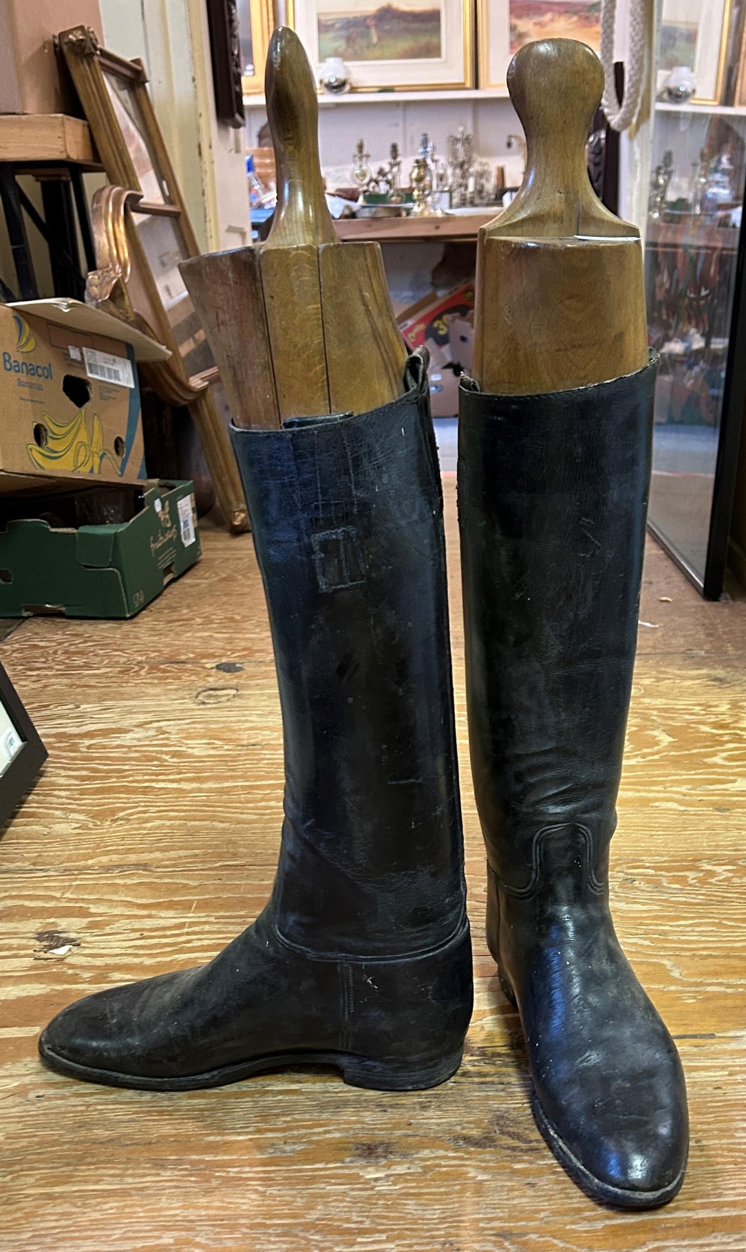 A pair of leather riding boots, with trees (2) Length of foot of boot tree: 29.5 cm