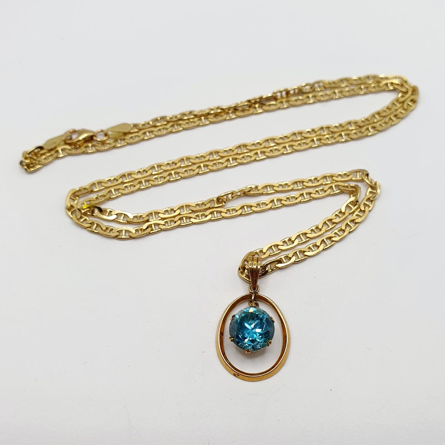 An 18ct gold chain, with a yellow metal and aquamarine pendant, 15.2 g (all in) Chain length: 60