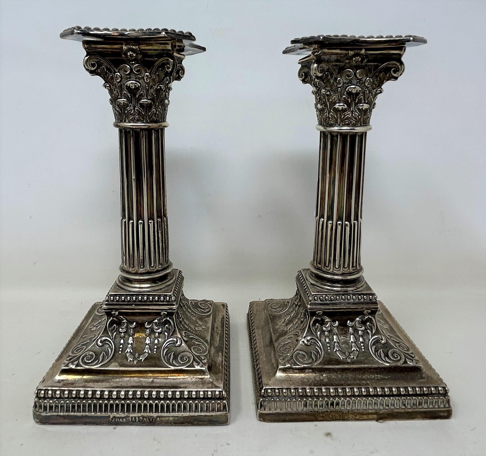 A pair of George V silver candlesticks, in the form of Corinthian columns, bases filled, 17 cm