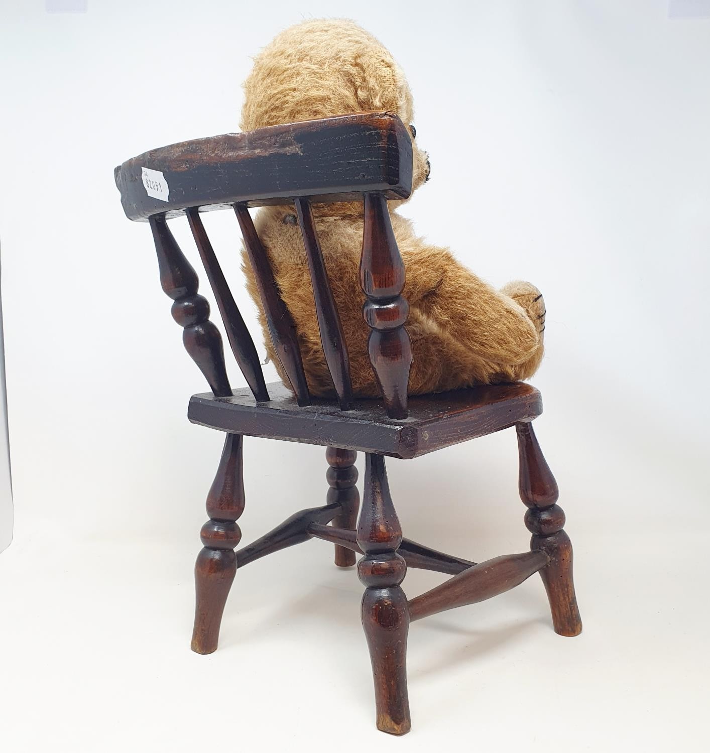 A late 19th/early 20th century child's elm stick back chair, on turned legs joined by an H - Image 2 of 2