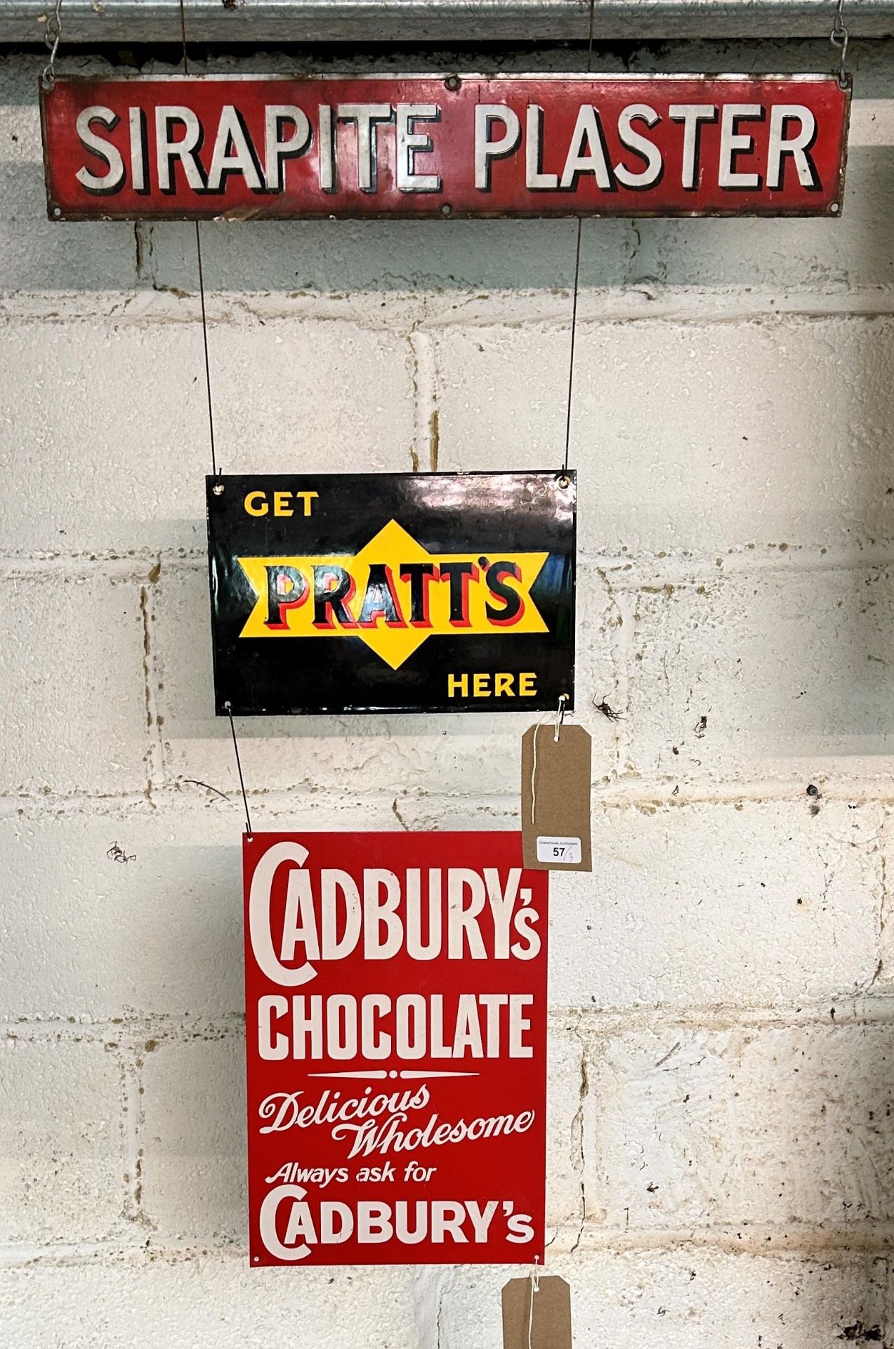 A Sirapite Plaster enamel sign, approx. 59 cm wide, and two reproduction signs (3) Being sold