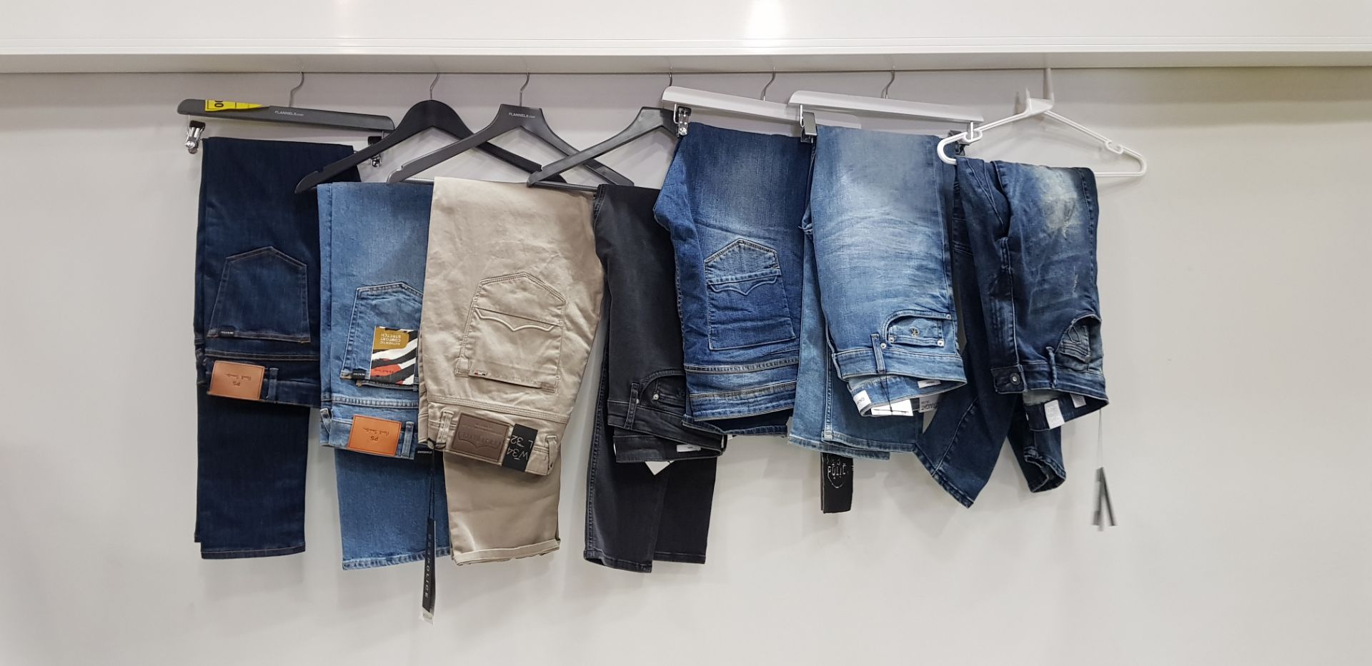 7 X BRAND NEW MIXED DESIGNER JEAN LOT CONTAINING POLICE, CALVIN KLEIN AND PAUL SMITH JEANS IN