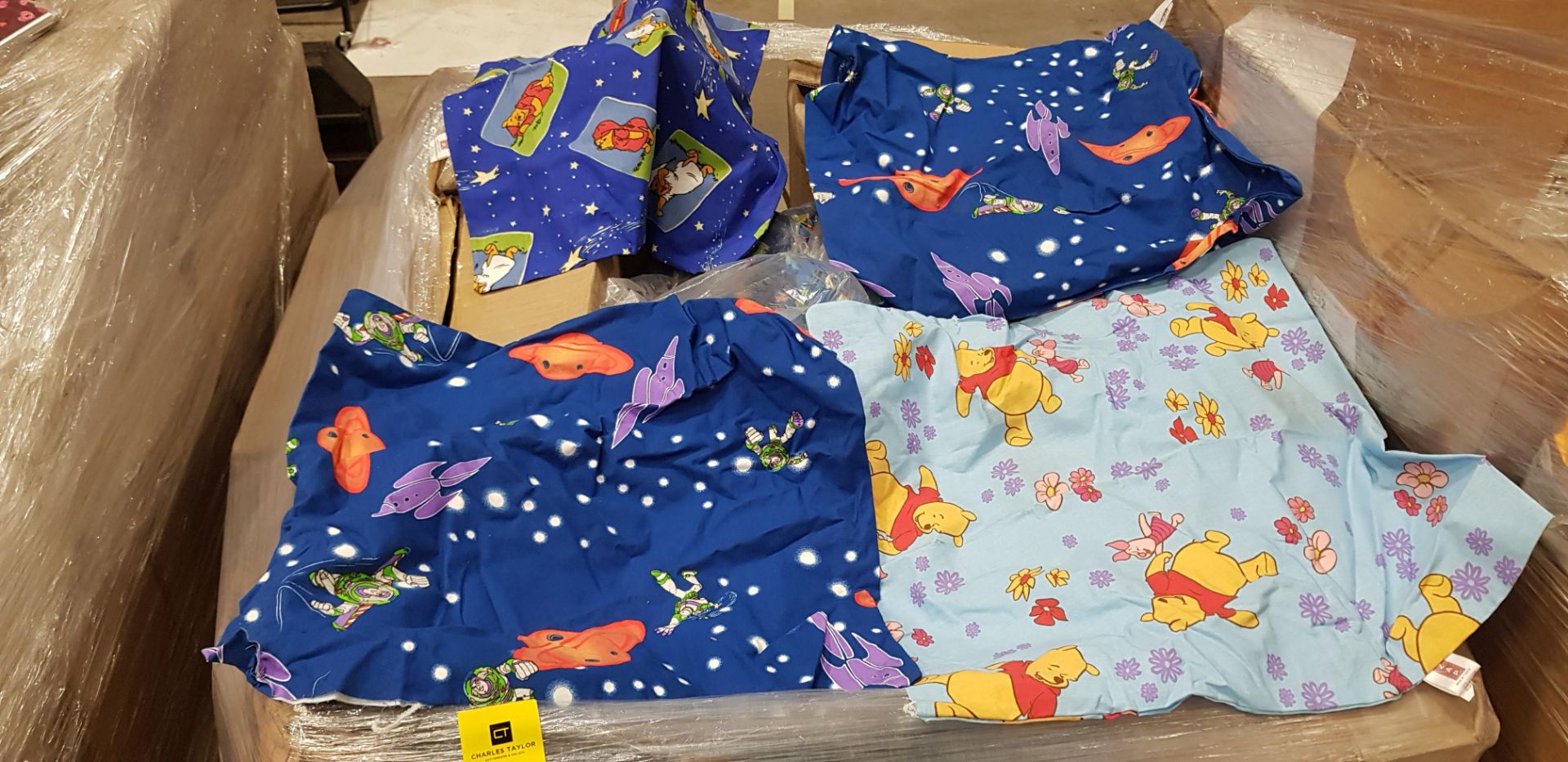 FULL PALLET OF UNFINISHED CUSHION COVERS IN VARIOUS STYLES AND SIZES IE WINNIE THE POOH AND BUZZ