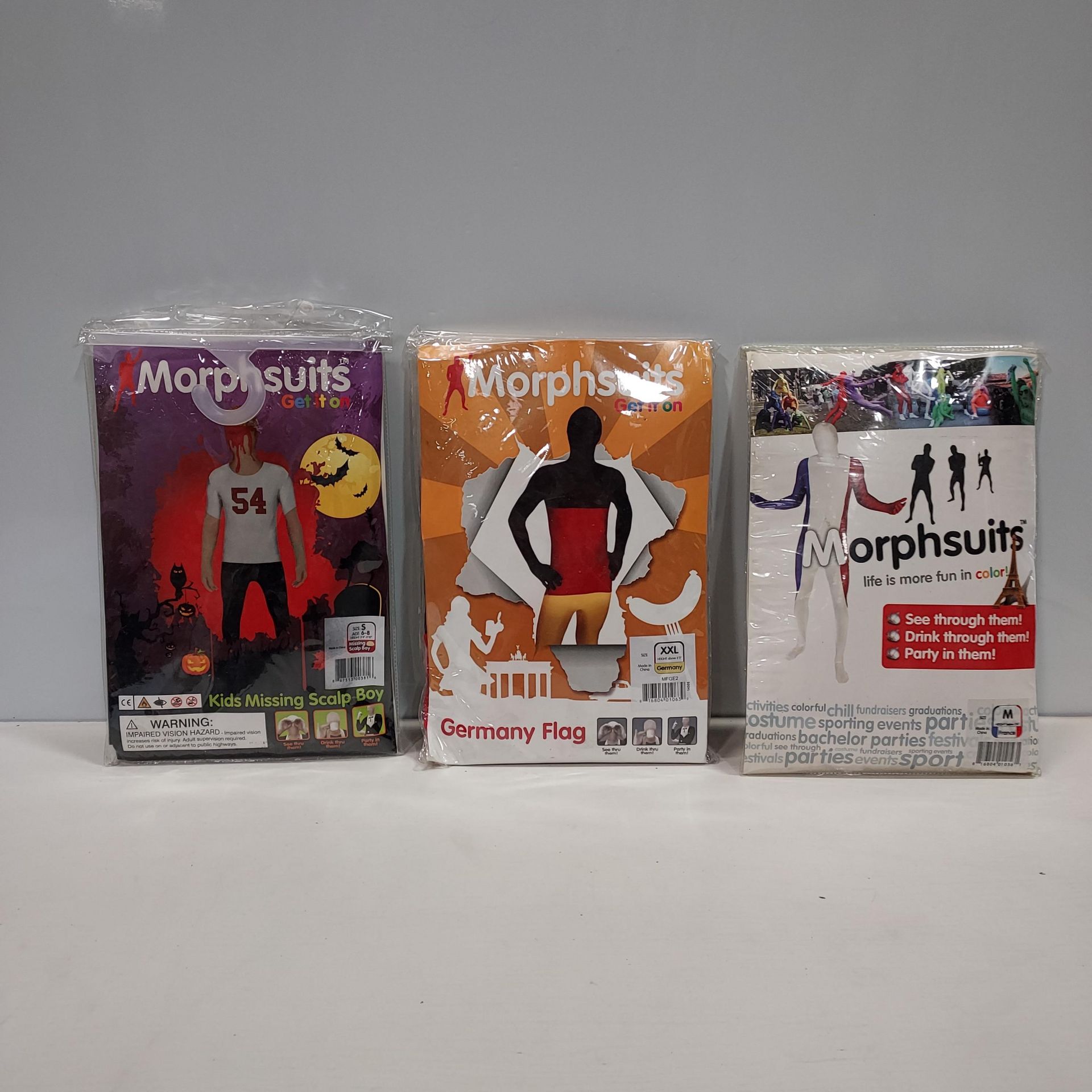 20 X BRAND NEW MORPHSUITS IN VARIOUS STYLES AND SIZES IE, FRENCH FLAG, GERMAN FLAG AND MISSING SCALP