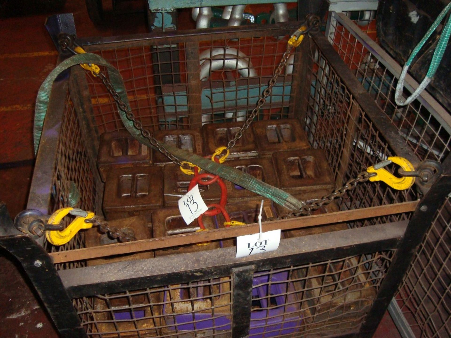 A quantity of test weights in a stillage, as lotted