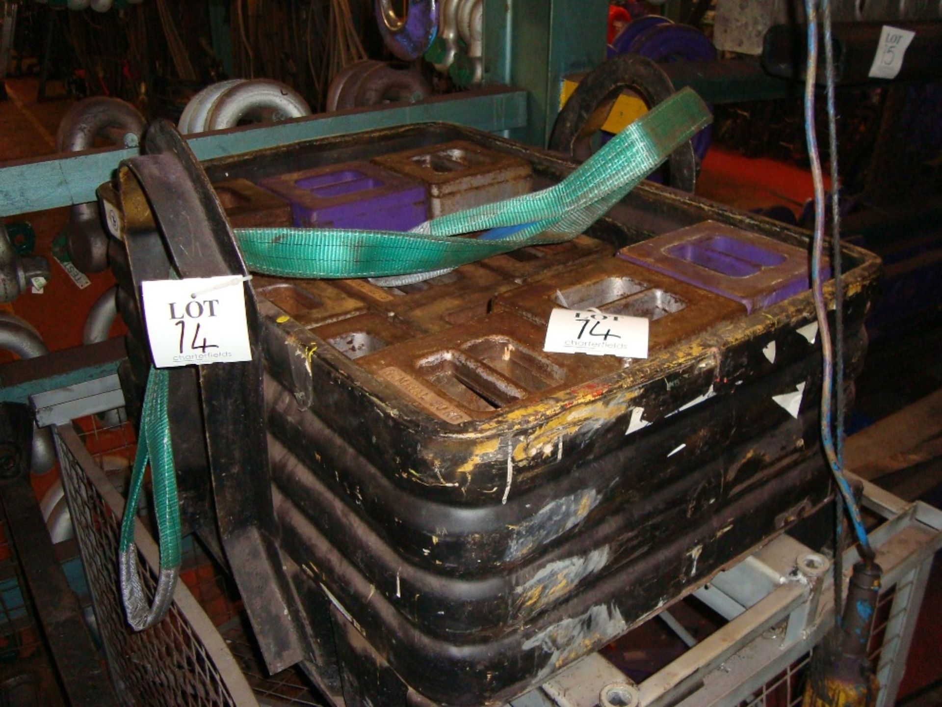 A quantity of test weights in a stillage, as lotted