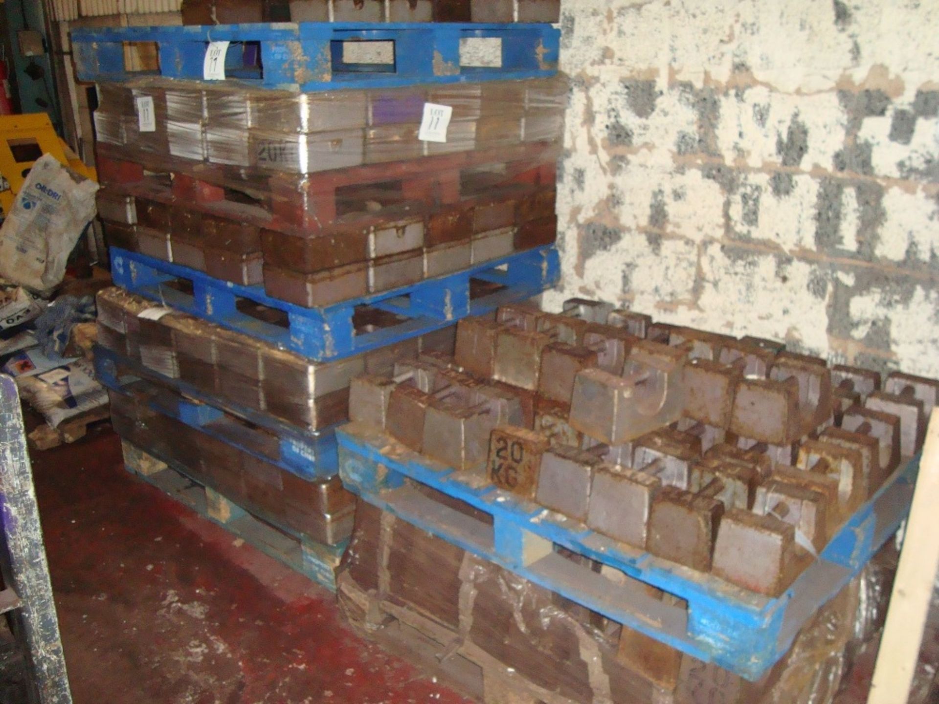 A quantity of test weights on seven pallets, as lotted, together with two mobile lifting trollies