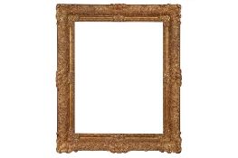 A FRENCH LOUIS XIV STYLE CARVED AND GILDED FRAME