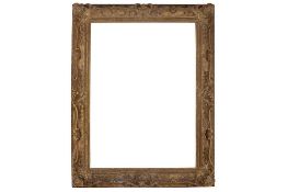 A FRENCH LOUIS XV CARVED, PIERCED AND SWEPT GILDED FRAME