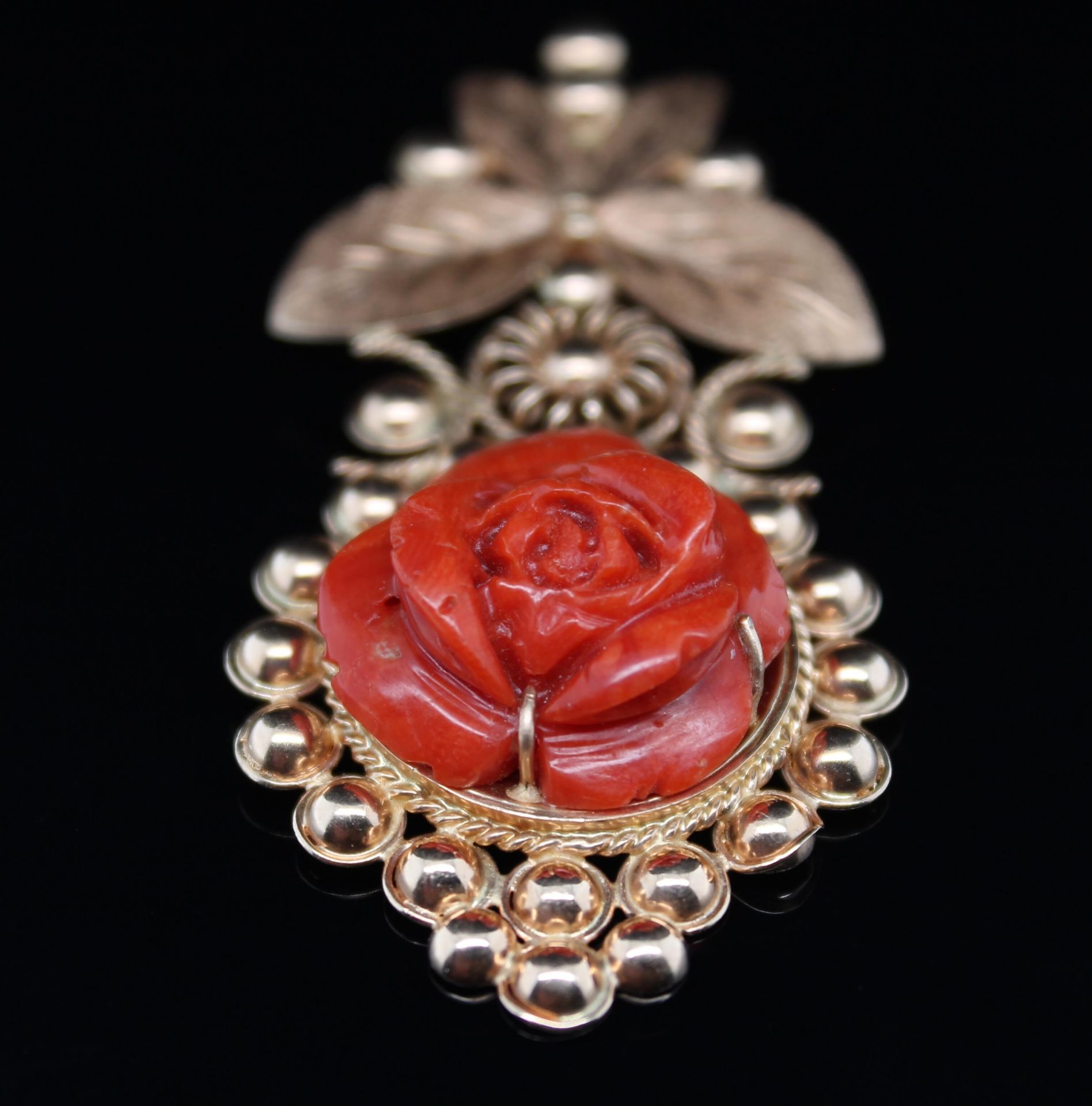 Pendant with carved coral flower