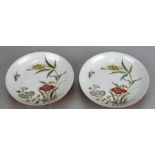 A pair of Chinese dishes decorated with flowers and a butterfly in enamel colours, the exterior with