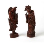 A pair of Chinese carved hardwood figures, 18cms high (2).