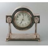 A silver plated cased mantle clock on lion mask supports, the white dial with Roman numerals,