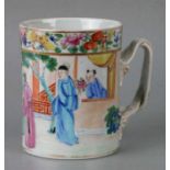 A mid 19th century Chinese Canton porcelain mug decorated with figures examining a scroll, 11cms