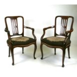 A pair of 19th century mahogany elbow chairs with upholstered seatsCondition ReportOne chair has had