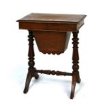 A Victorian mahogany sewing table, the lift-up lid enclosing a sectioned interior, on turned