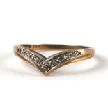 A 9ct gold diamond set wishbone ring. Approx. UK size N. 1.4g