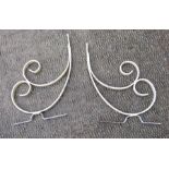 A pair of painted wrought iron shelf brackets.