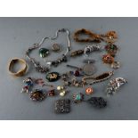 A quantity of costume jewellery to include brooches and necklaces.