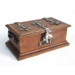 An oak box with silver plated mounts and sectioned interior, 30cms wide.