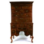 A George II walnut chest-on-stand with later adaptions, the top with an arrangement of two short and