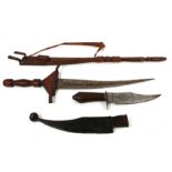 A North African sword in tooled leather scabbard with multiple hidden blades, 10cms long; together