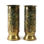 A pair of WWI trench art brass artillery shells modelled in the form of vases with hammered relief