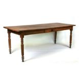 A continental fruitwood farmhouse table with three plank top, single frieze drawer and turned
