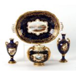 A Coalport 18th century style sucrier and matching stand decorated with vignettes depicting