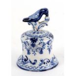 A Delft blue & white hand bell with bird finial, 10cms high (a/f).