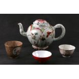 A Chinese famille teapot decorated with flowers and applied scrolling flowers and foliage, 12cms