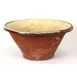 A late 19th / early 20th century glazed earthenware dairy bowl, 46cms diameter.Condition