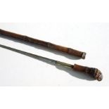 A cane sword stick with 61.5cms (24.25ins) square section steel blade
