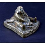 A Victorian brass novelty inkwell in the form of a fat man carving a roasted chicken, 10cms high.