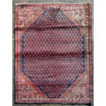 A Persian Arak hand knotted woollen rug, on a blue ground, 172 by 105cms (sh41).