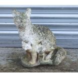 A well weathered reconstituted stone figure of a seated fox, 42cms high.