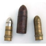 Three WW1 petrol lighters shaped like artillery shells. The largest being 9cms (3.5ins) tall by 3cms